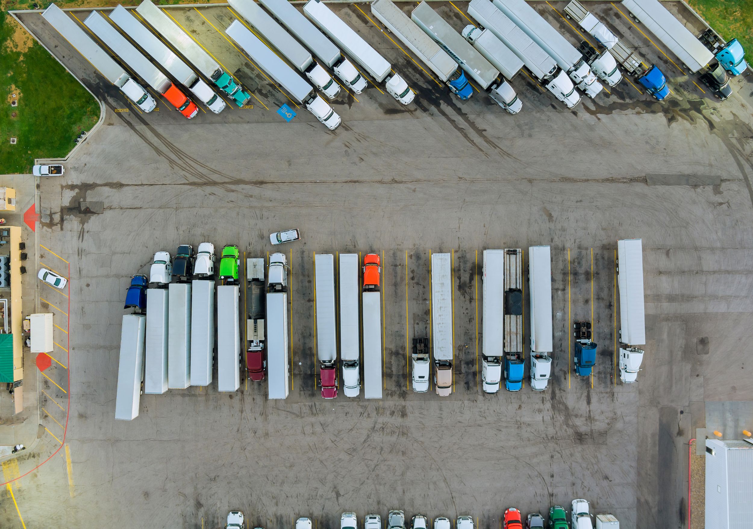 Aerial view of freight trucks parked at a logistics yard